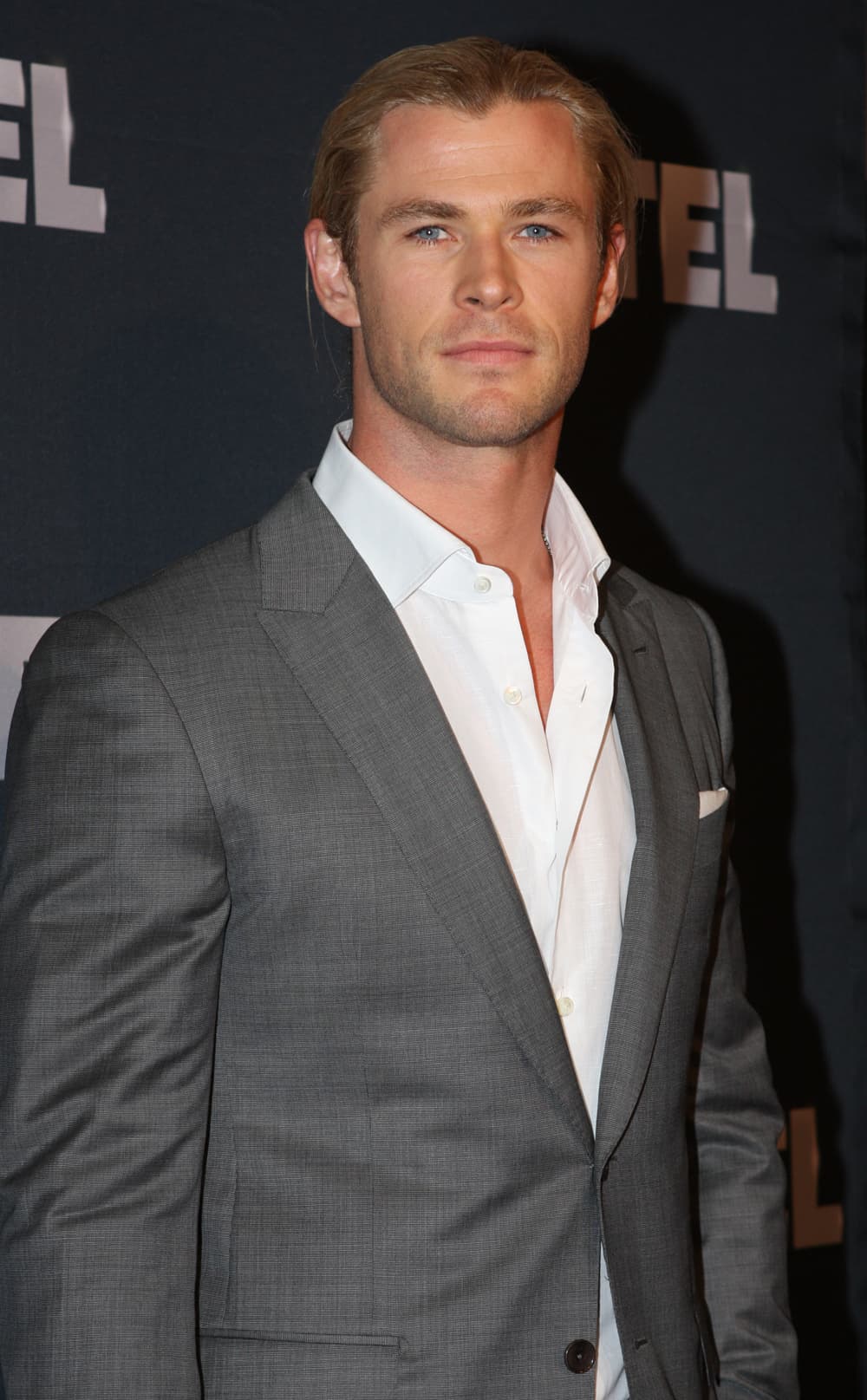 Alternate press angle — blue-eyed gaze and strong chin projection.