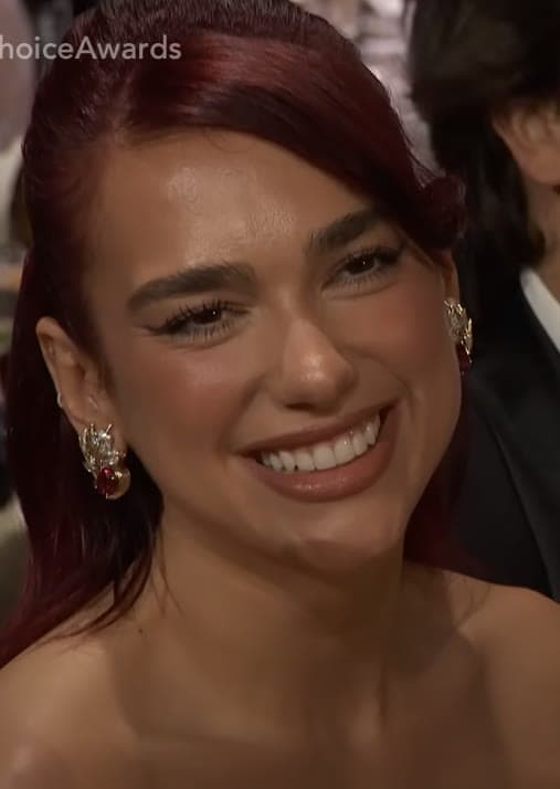 Awards carpet — soft-smile finish under high-key press light.
