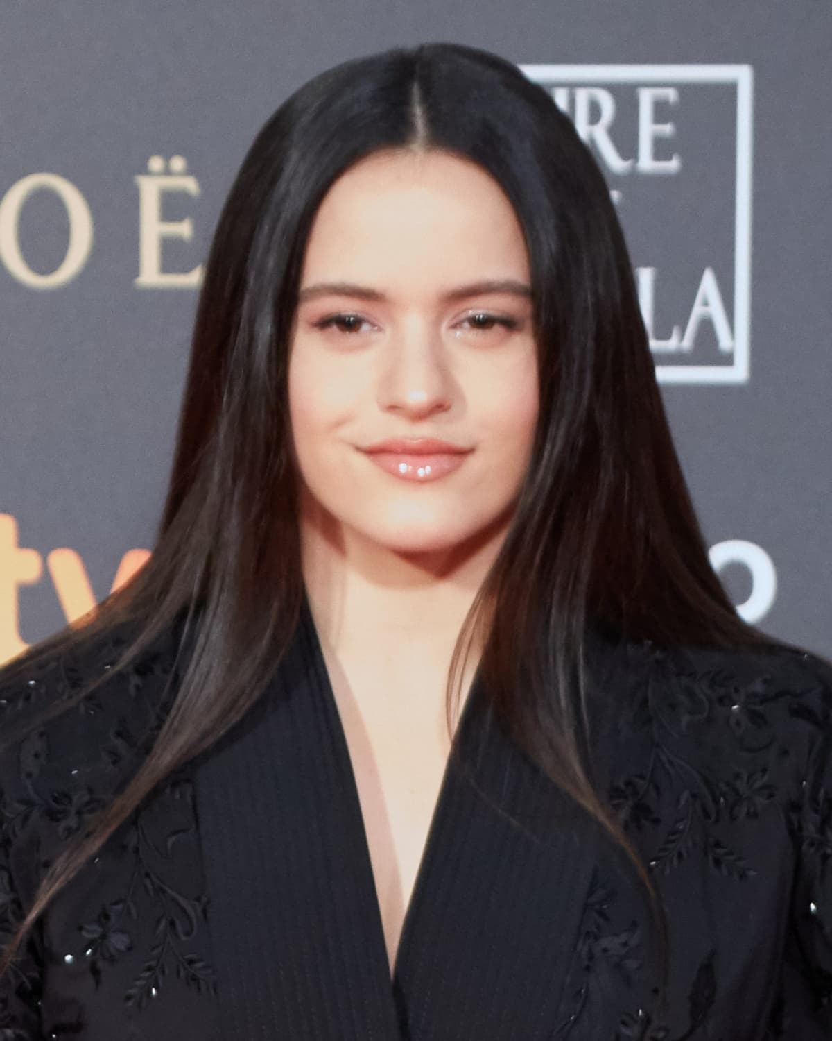 Clean frontal — dark gaze, arched brows, soft defined jaw under soft press key.