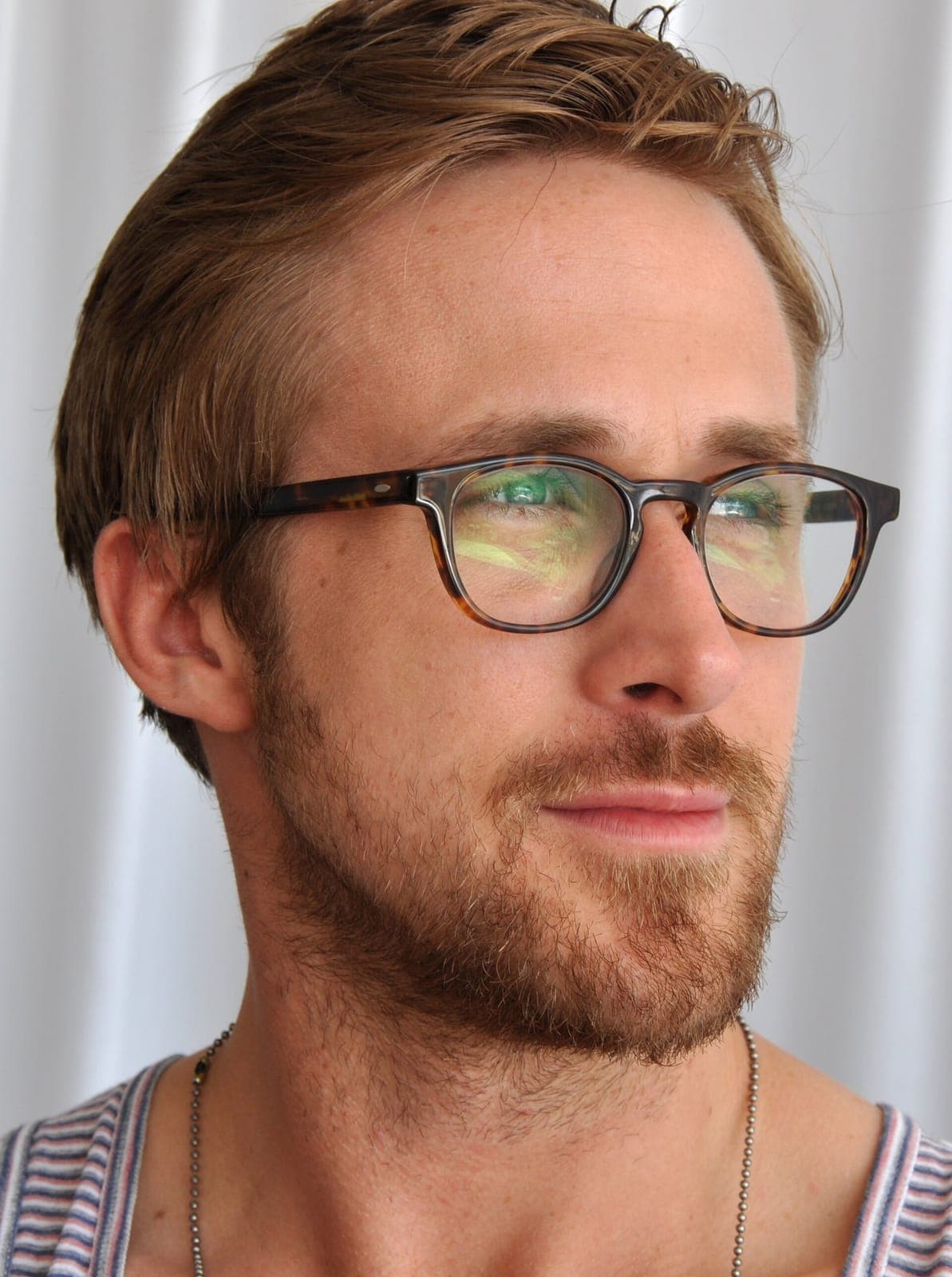 Cannes frontal — clean jaw taper, soft smile, short light-brown temple control under festival flash.