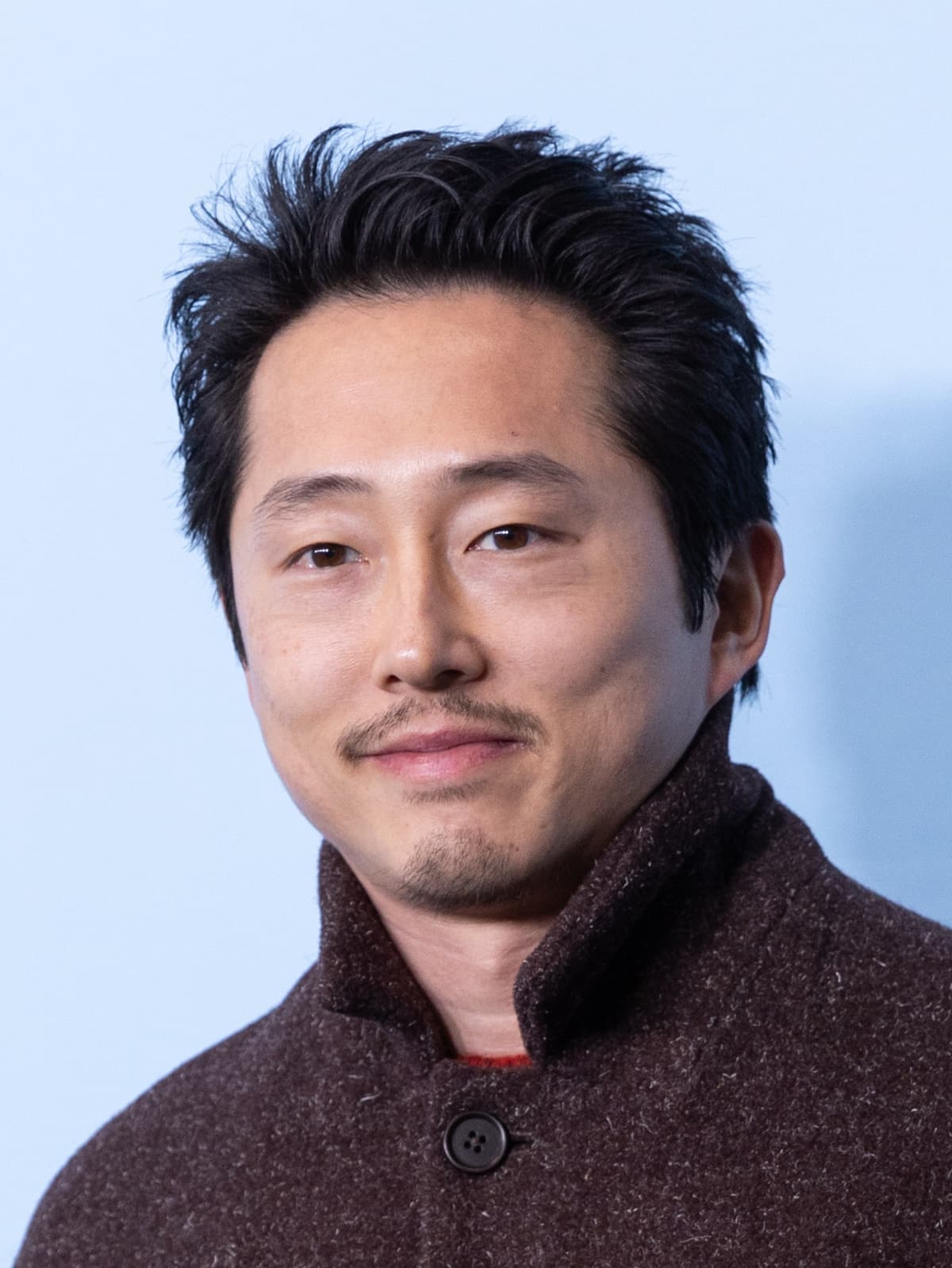 Sundance cropped frontal — warm Korean-American bone under festival key.